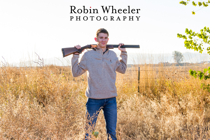 Senior photo of a boy with a shotgun, Ontario, Oregon