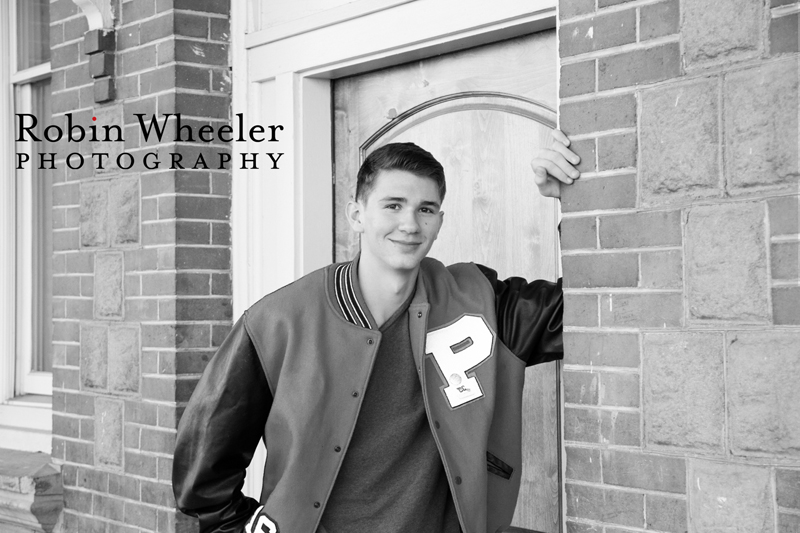 Black and white senior portrait of a boy with a Payette High School letterman jacket, Ontario, Oregon