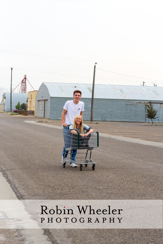 High school senior pushing his girlfriend in a shopping cart, Ontario, Oregon