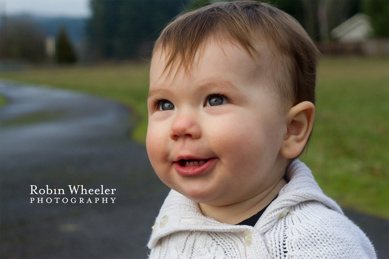 Baby looking up at parents and smiling, Dallas, Oregon