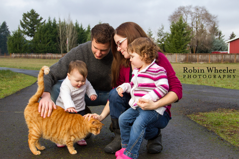 Family of four petting an orange cat, Dallas, Oregon