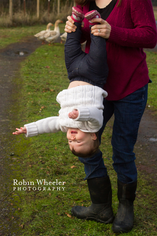 Mother holding baby upside down, Dallas, Oregon