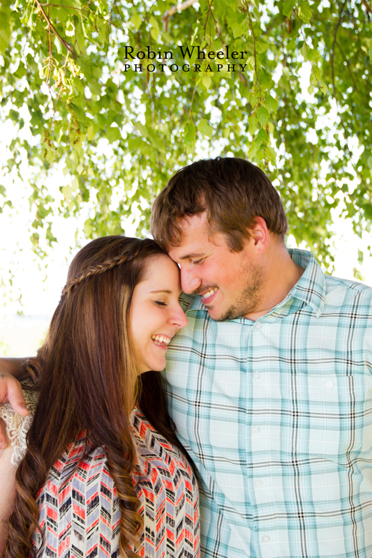 Couple hugging under a tree