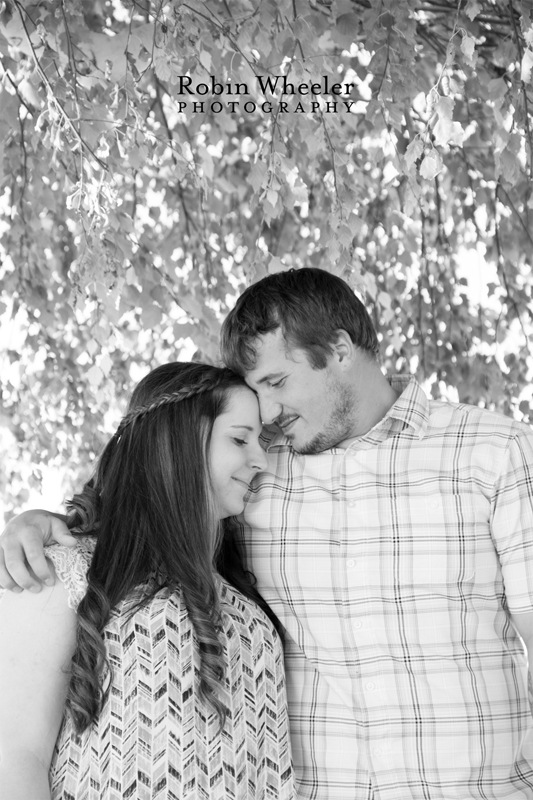 Black and white photo of a couple under a tree