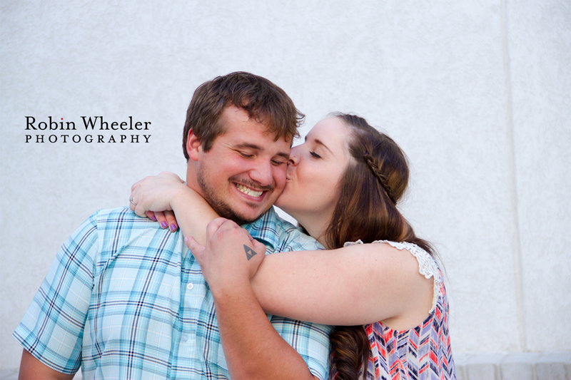 Woman kissing man on the cheek