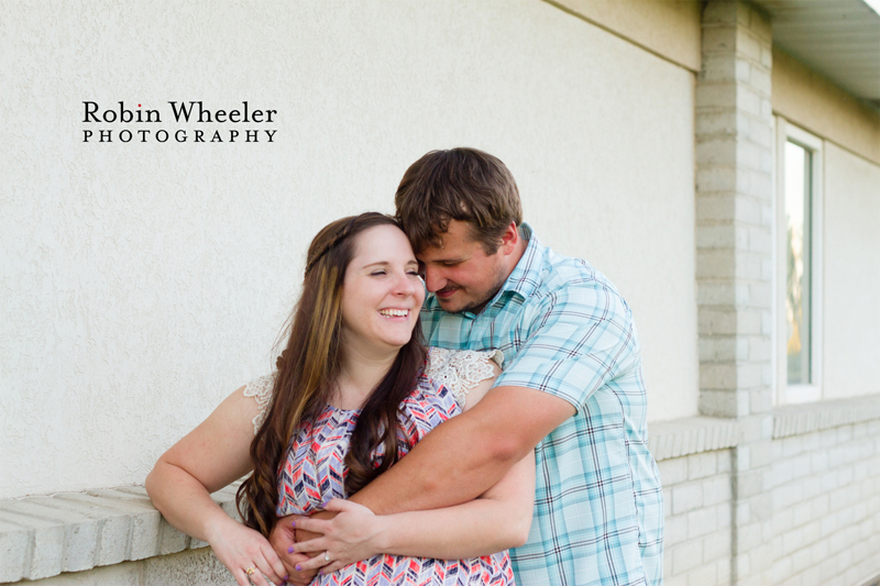 Couple standing together next to a building