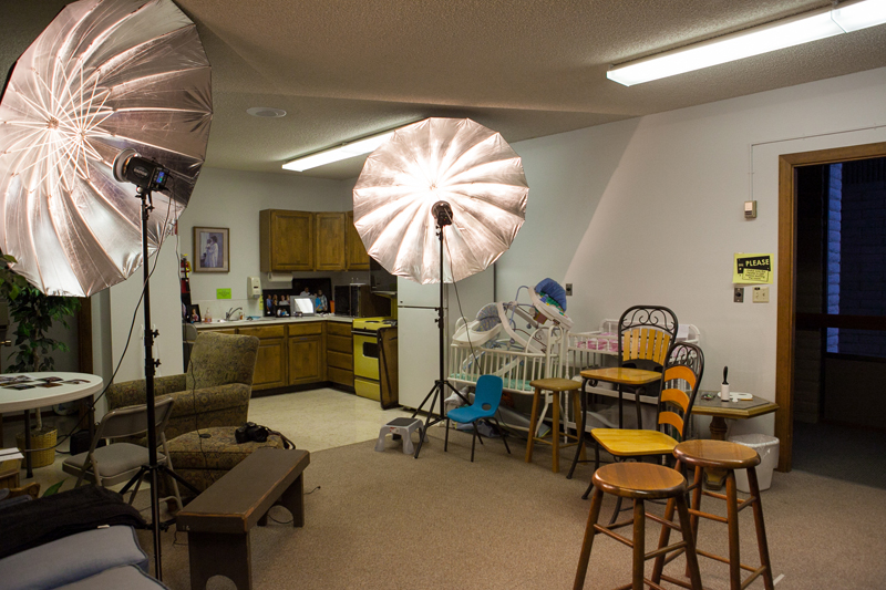 chairs and studio lets with umbrellas set up for portraits