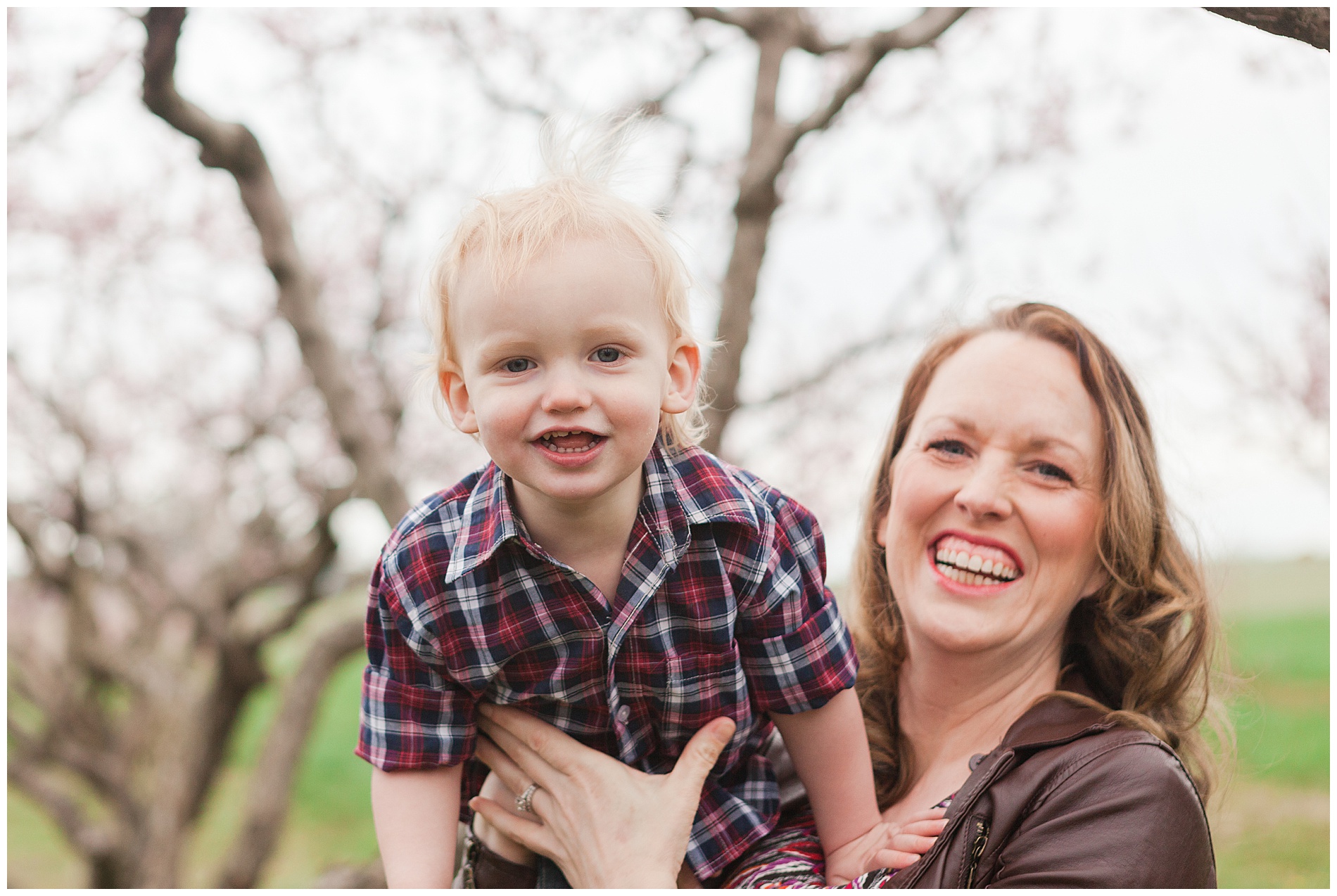 Fun and relaxed family portraits in a peach orchard with pink blossoms | Idaho family photographer | Robin Wheeler Photography