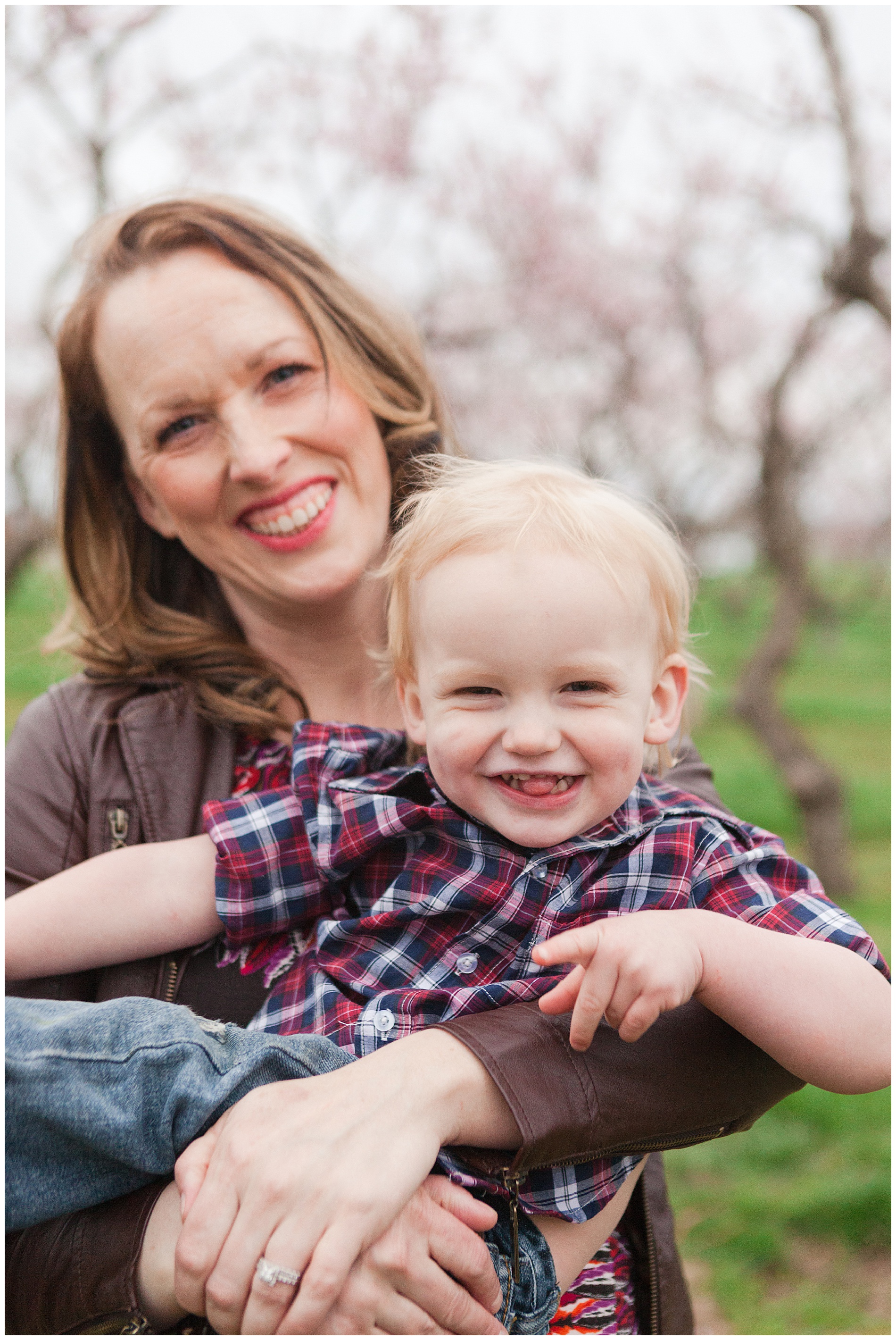 Fun and relaxed family portraits in a peach orchard with pink blossoms | Idaho family photographer | Robin Wheeler Photography