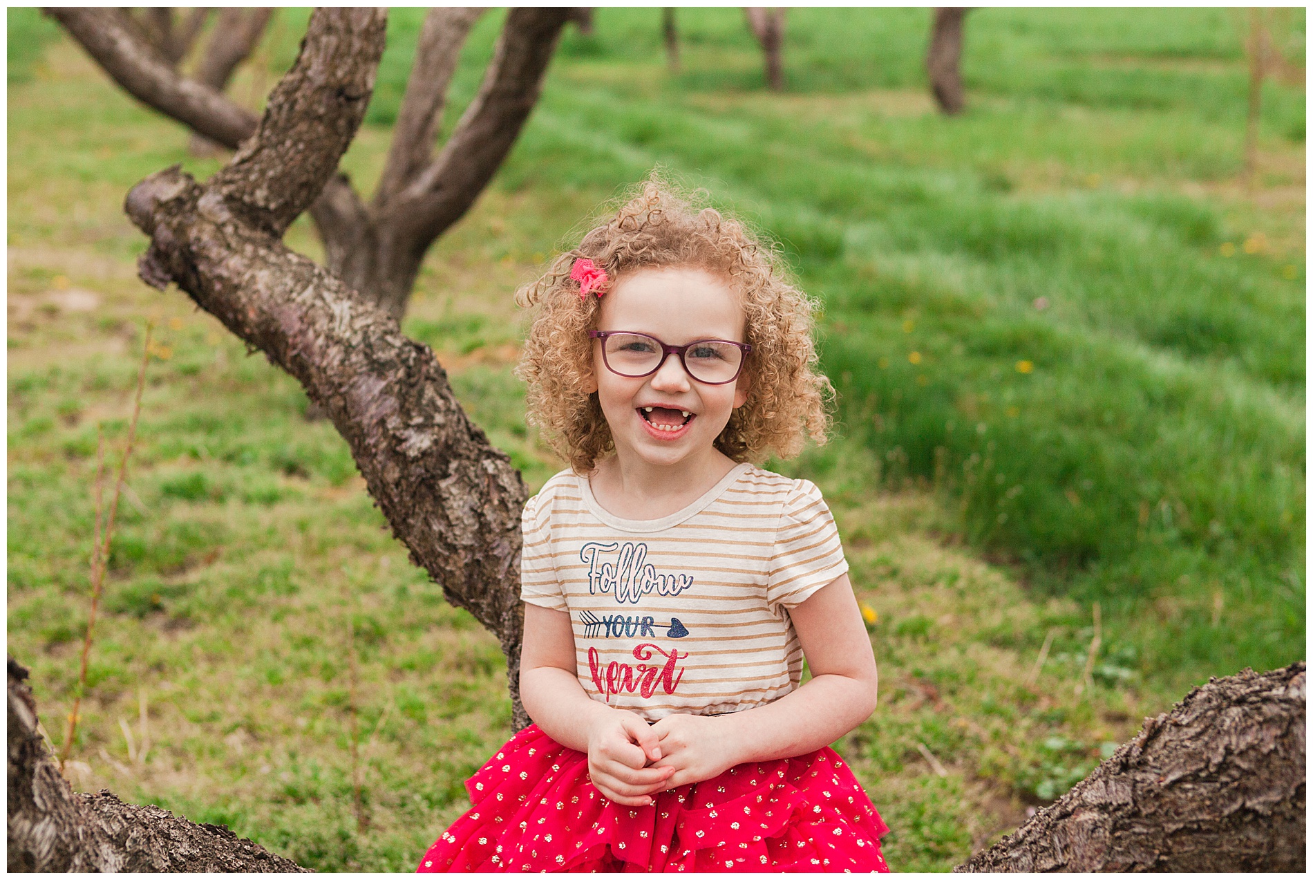 Fun and relaxed family portraits in a peach orchard with pink blossoms | Idaho family photographer | Robin Wheeler Photography