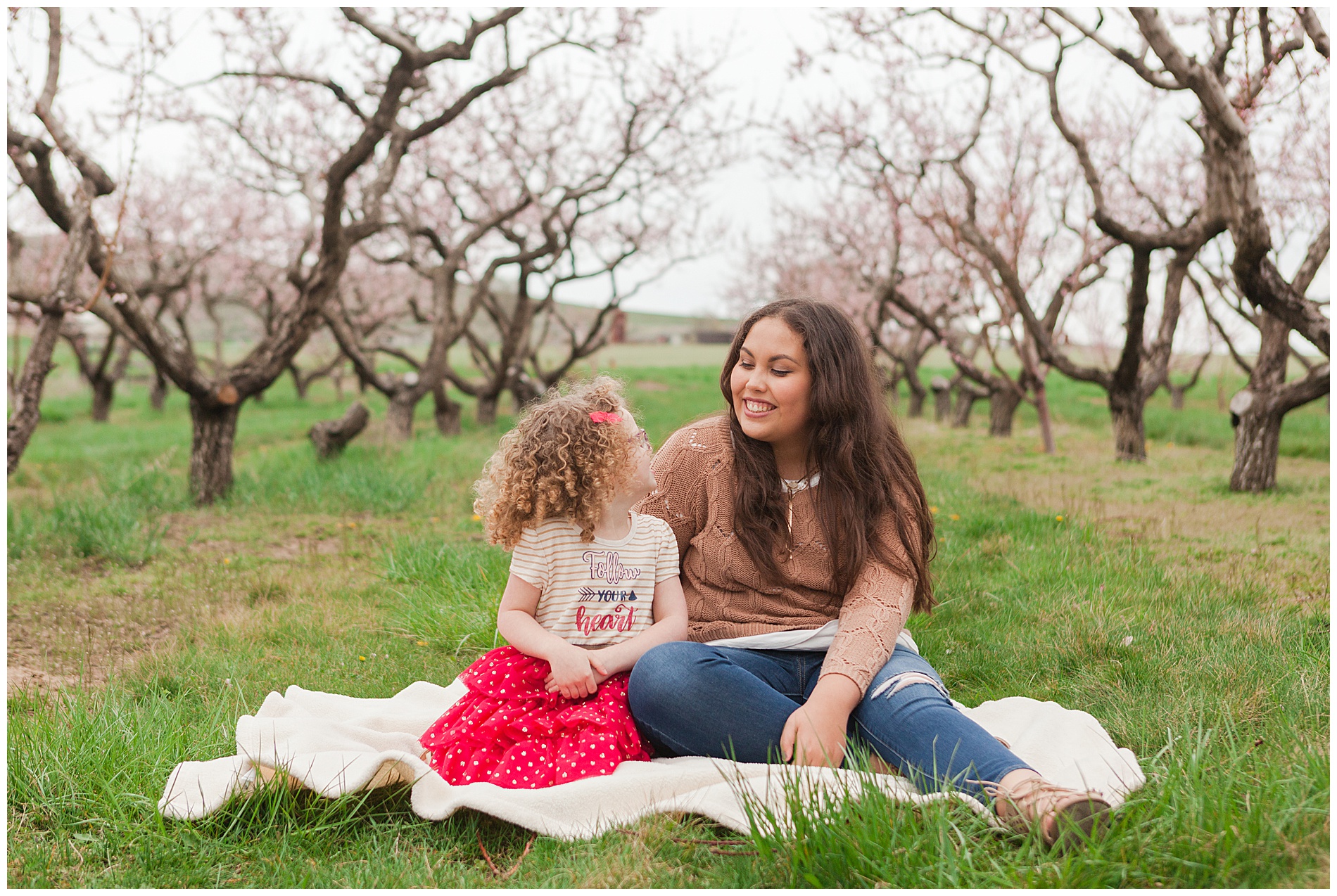 Fun and relaxed family portraits in a peach orchard with pink blossoms | Idaho family photographer | Robin Wheeler Photography