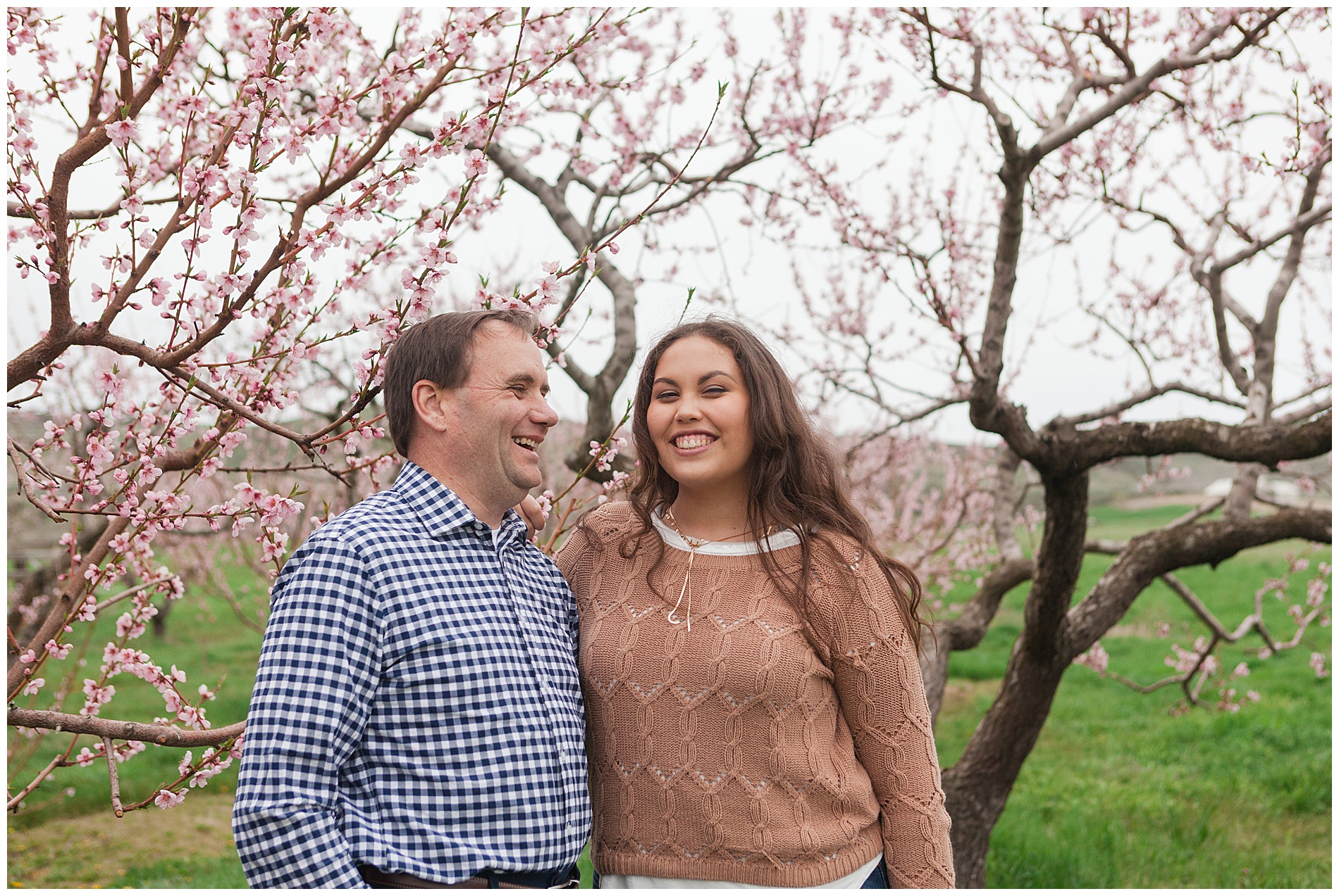 Fun and relaxed family portraits in a peach orchard with pink blossoms | Idaho family photographer | Robin Wheeler Photography