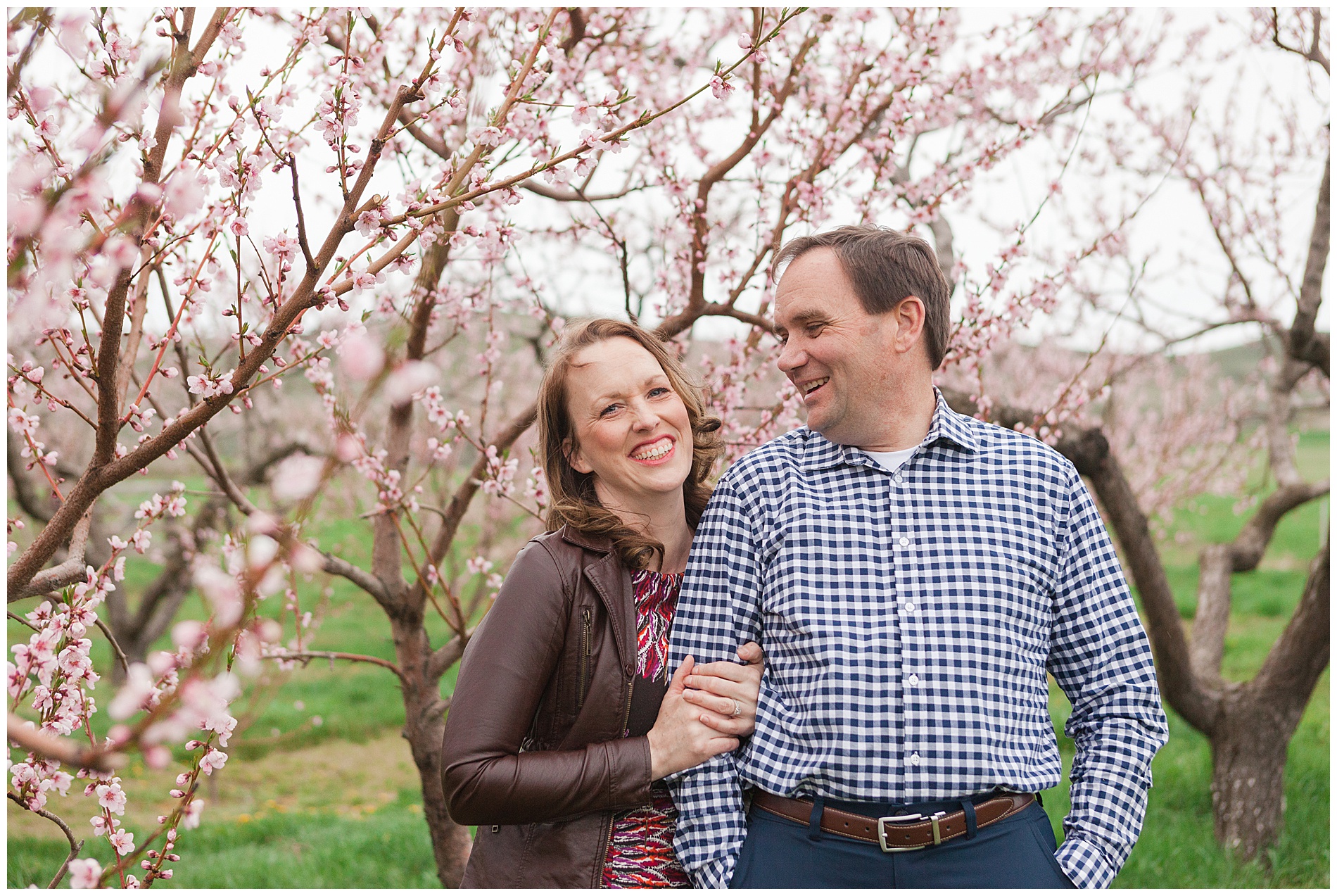 Fun and relaxed family portraits in a peach orchard with pink blossoms | Idaho family photographer | Robin Wheeler Photography