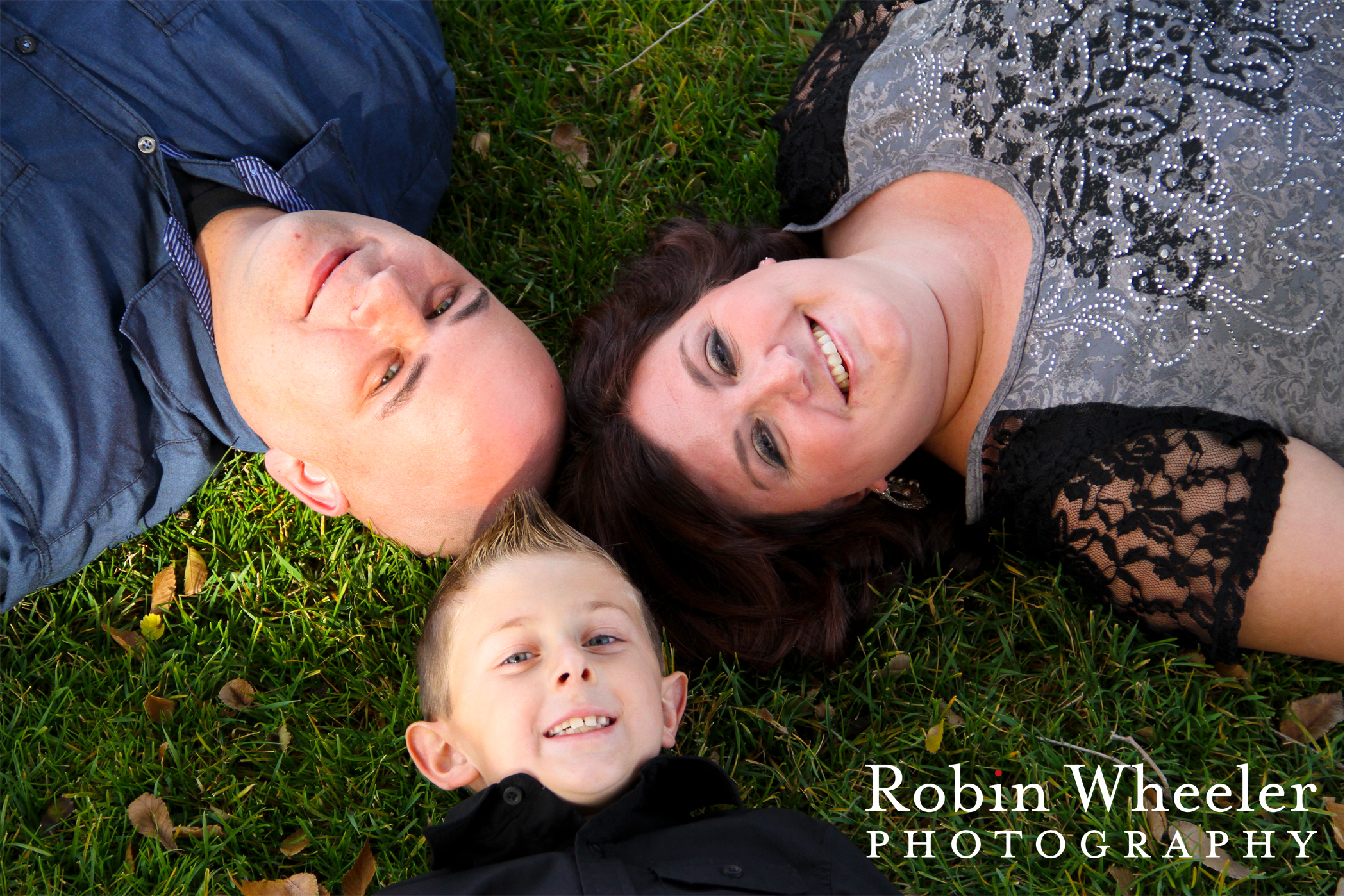 family lying on the ground with heads in a circle