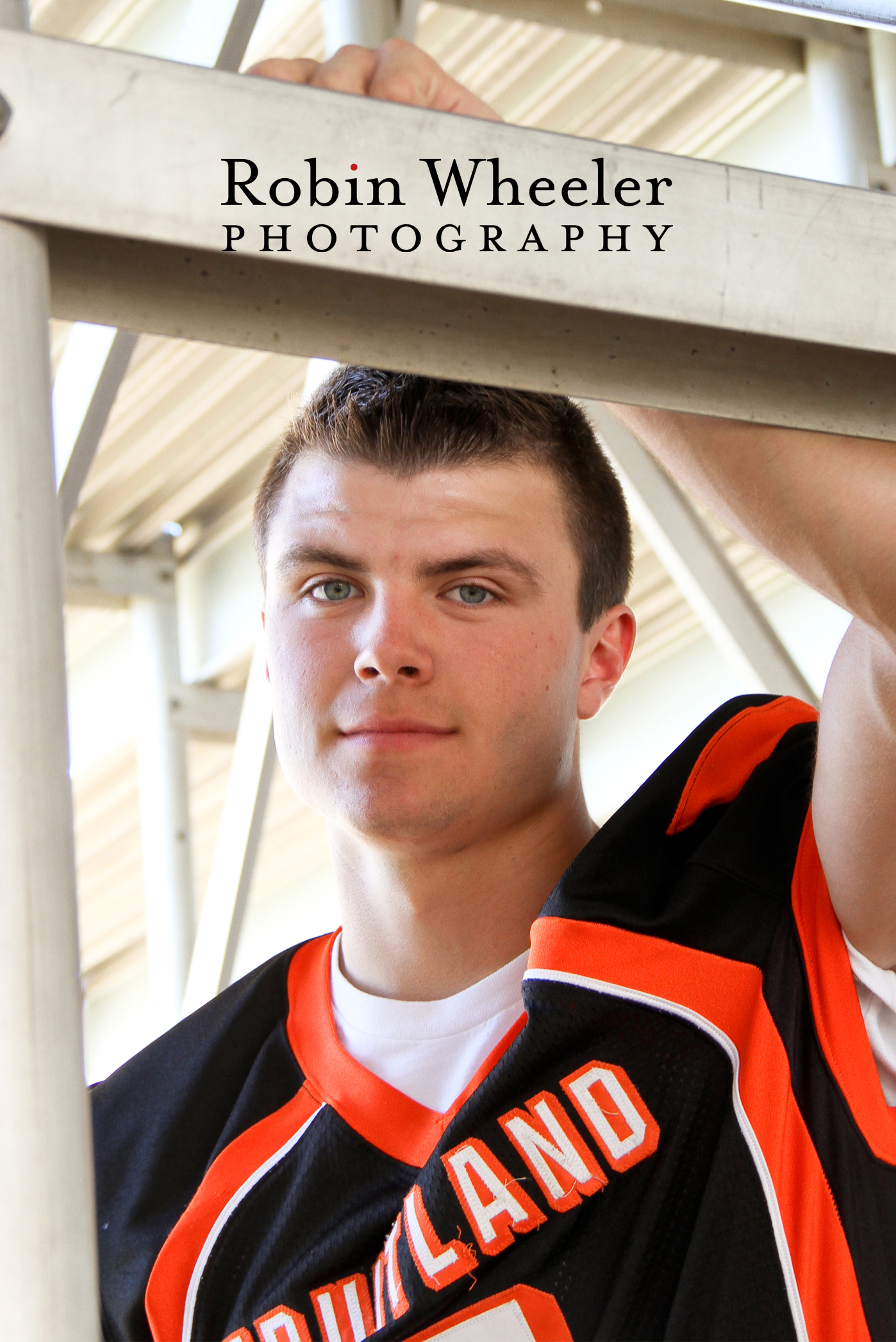 Senior football player under the bleachers at his high school