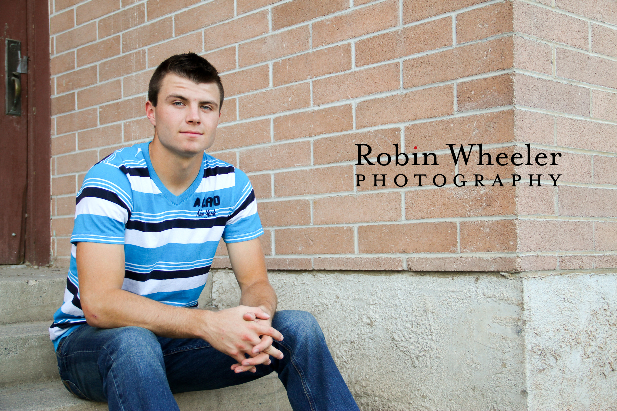 High school senior sitting on steps outside the old school in Fruitland, Idaho