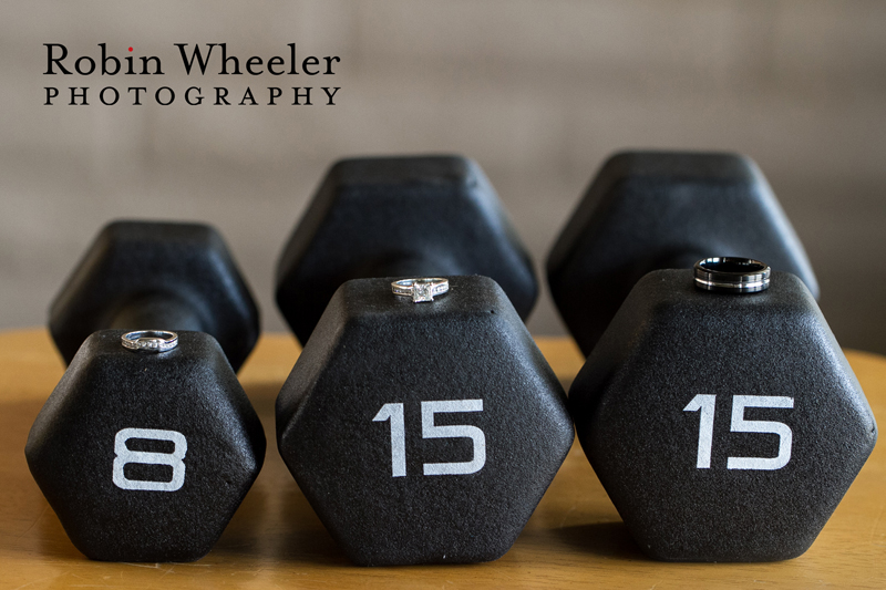 Photo of wedding rings on three dumbbells with the weights 8-15-15 indicating the wedding date, Ontario, Oregon