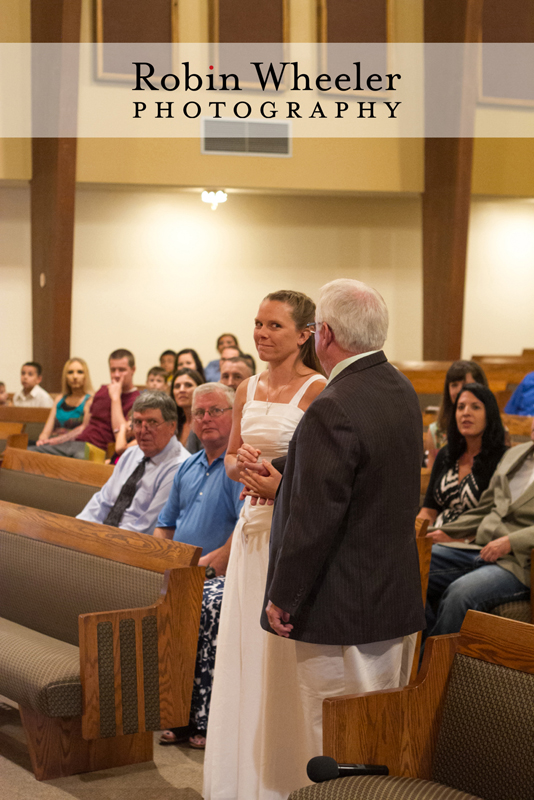 Bride wondering what her father is going to say before giving her away in the wedding ceremony, Ontario, Oregon