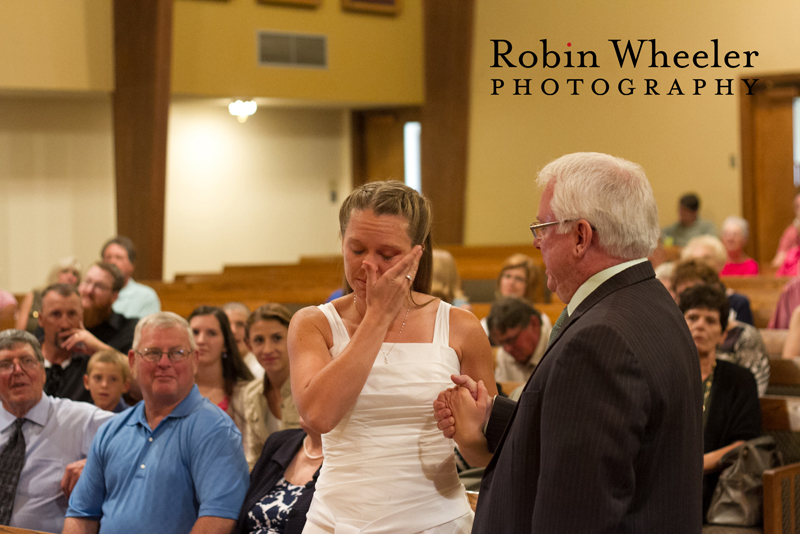 Bride wiping away a tear as her father gives her away, Ontario, Oregon