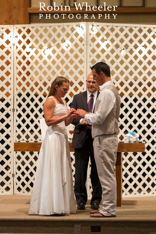 Bride placing ring on groom during wedding ceremony, Ontario, Oregon