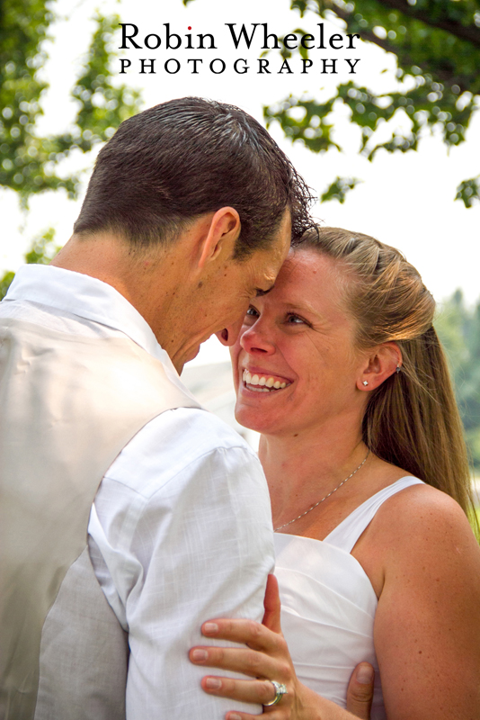 Bride smiling as groom leans in toward her, Ontario, Oregon