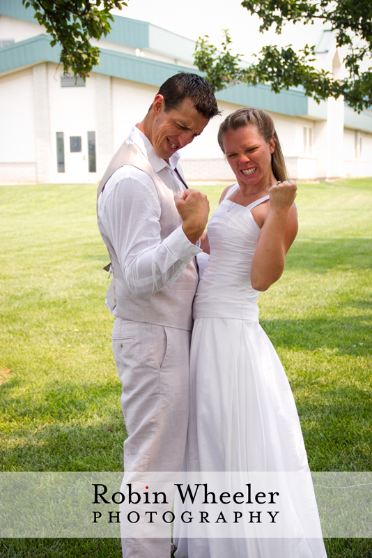 Groom and bride pumping fists in celebration, Ontario, Oregon