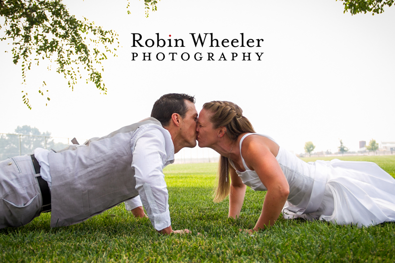 Crossfit groom and bride kissing while doing a push-up, Ontario, Oregon