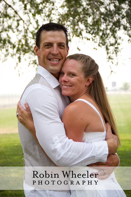 Portrait of groom and bride hugging and smiling, Ontario, Oregon