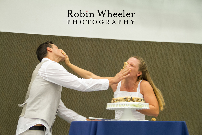 Groom and bride smashing wedding cake in each other's faces, Ontario, Oregon