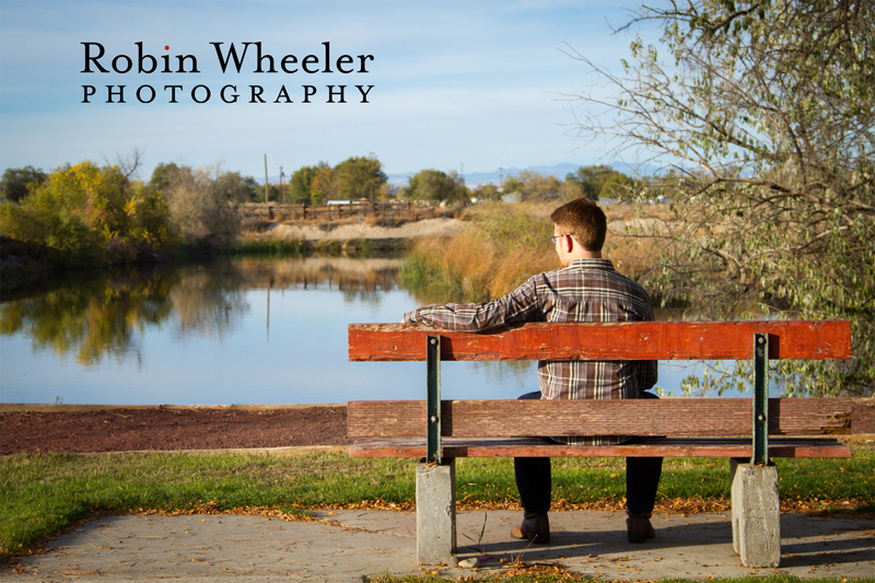 Photo of a high school senior sitting on a bench in Beck-Kiwanis Park in Ontario, Oregon