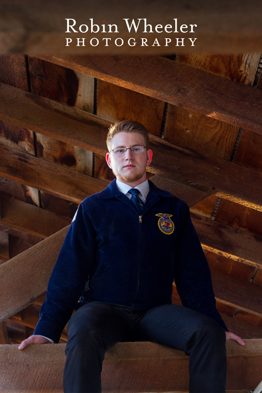 Photo of a high school senior in the rafters of a barn at the Malheur County Fairgrounds in Ontario, Oregon