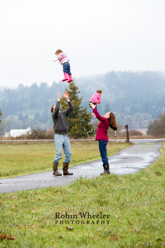 Parents tossing young children in the air, Dallas, Oregon