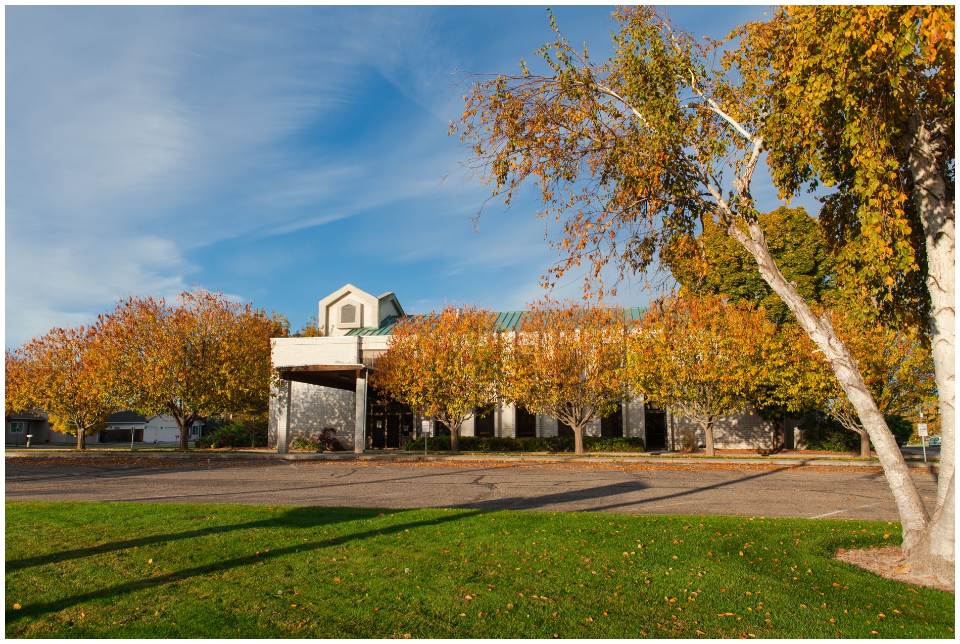 Church exterior on the wedding day with autumn leaves turning orange.