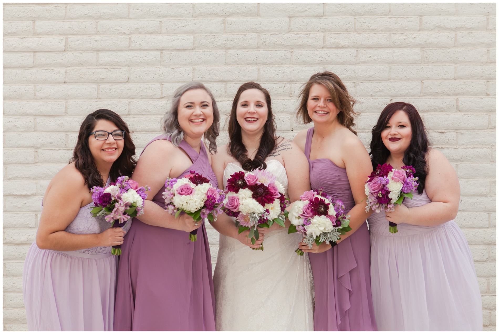 The bride and bridesmaids holding their bouquets