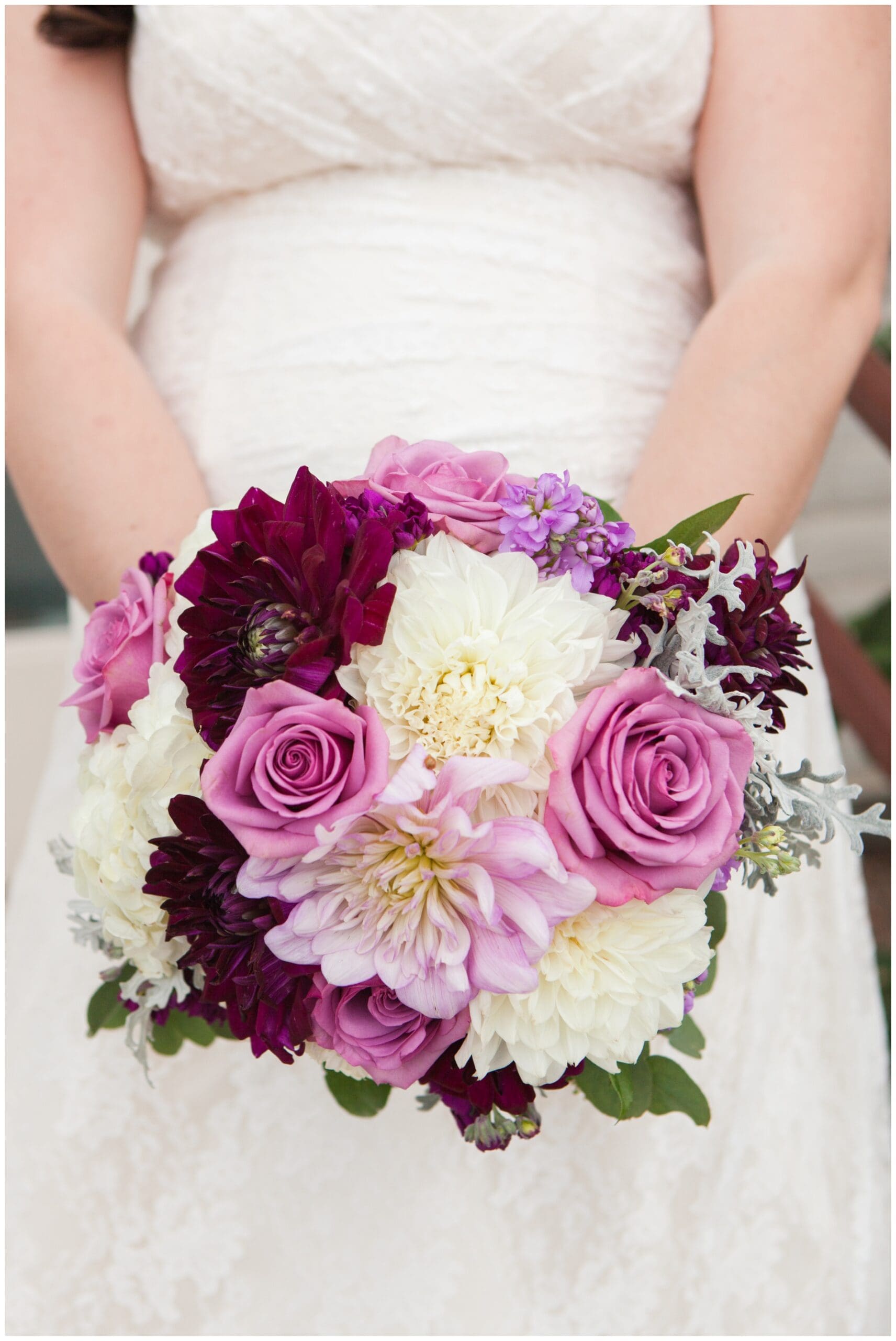 The bride's stunning bouquet of dark and light pinkish purple flowers
