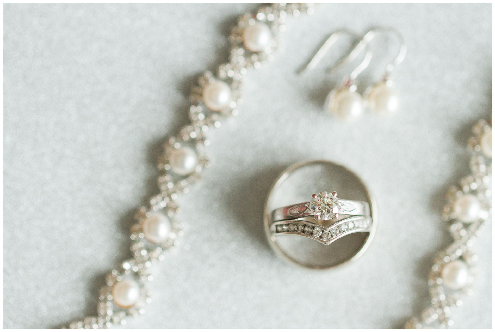 Wedding rings and jewelry on a white sparkly background