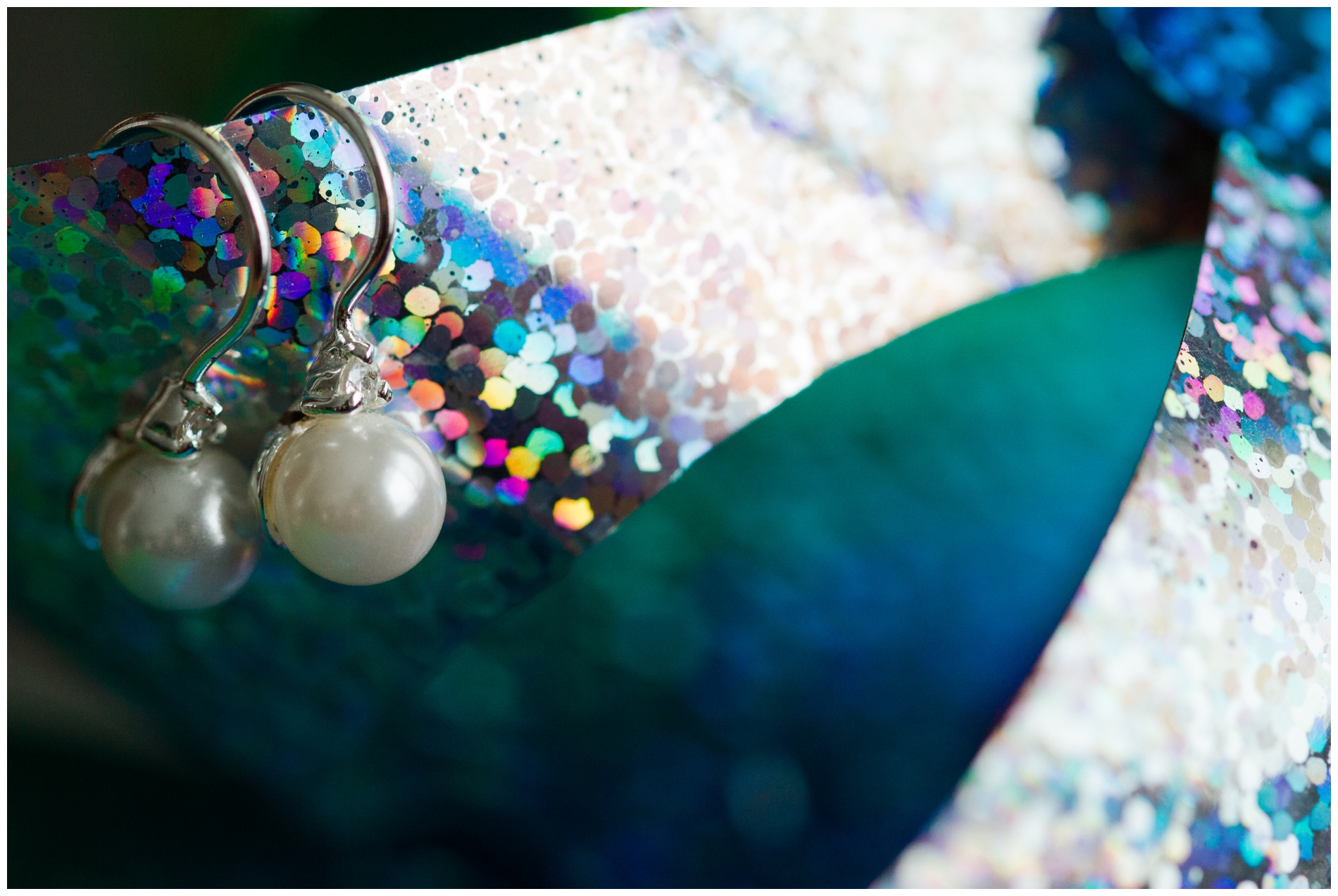 Pearl and diamond earrings on a pinwheel