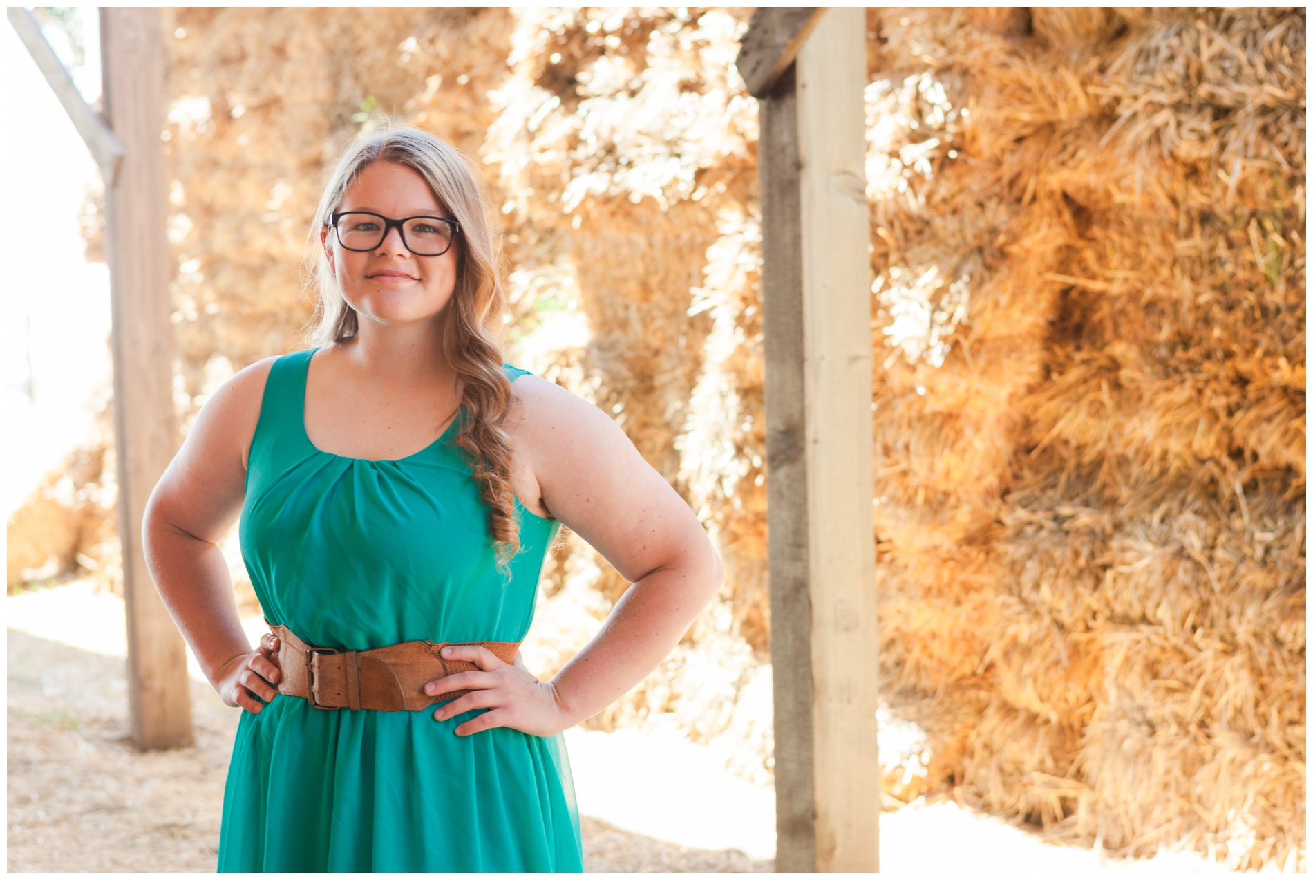 Senior picture of a girl in a hay shed in Ontario, Oregon.