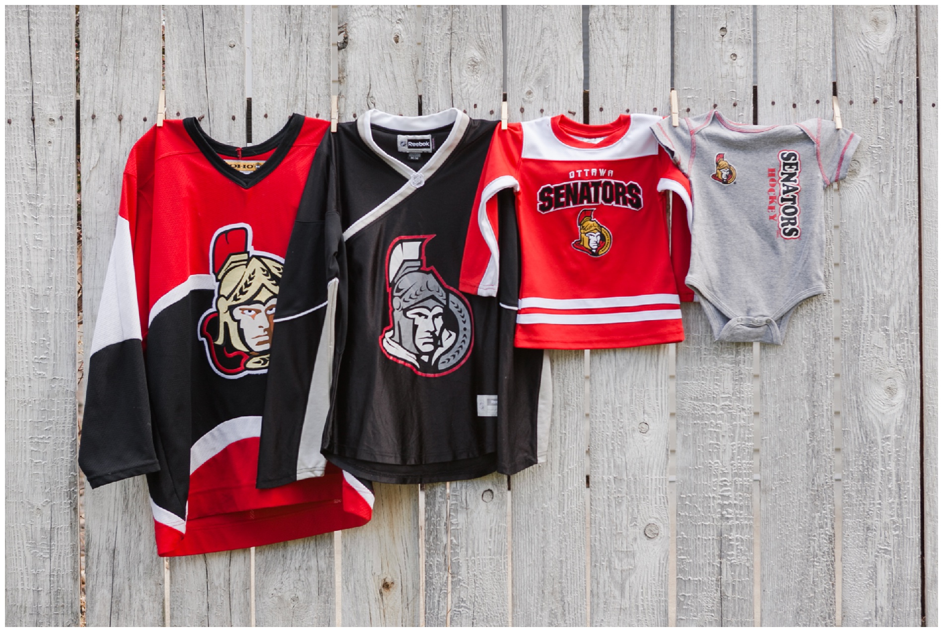 Pregnancy announcement: Two adults' Ottawa Senators jerseys, a toddler jersey, and a Senators baby onesie.