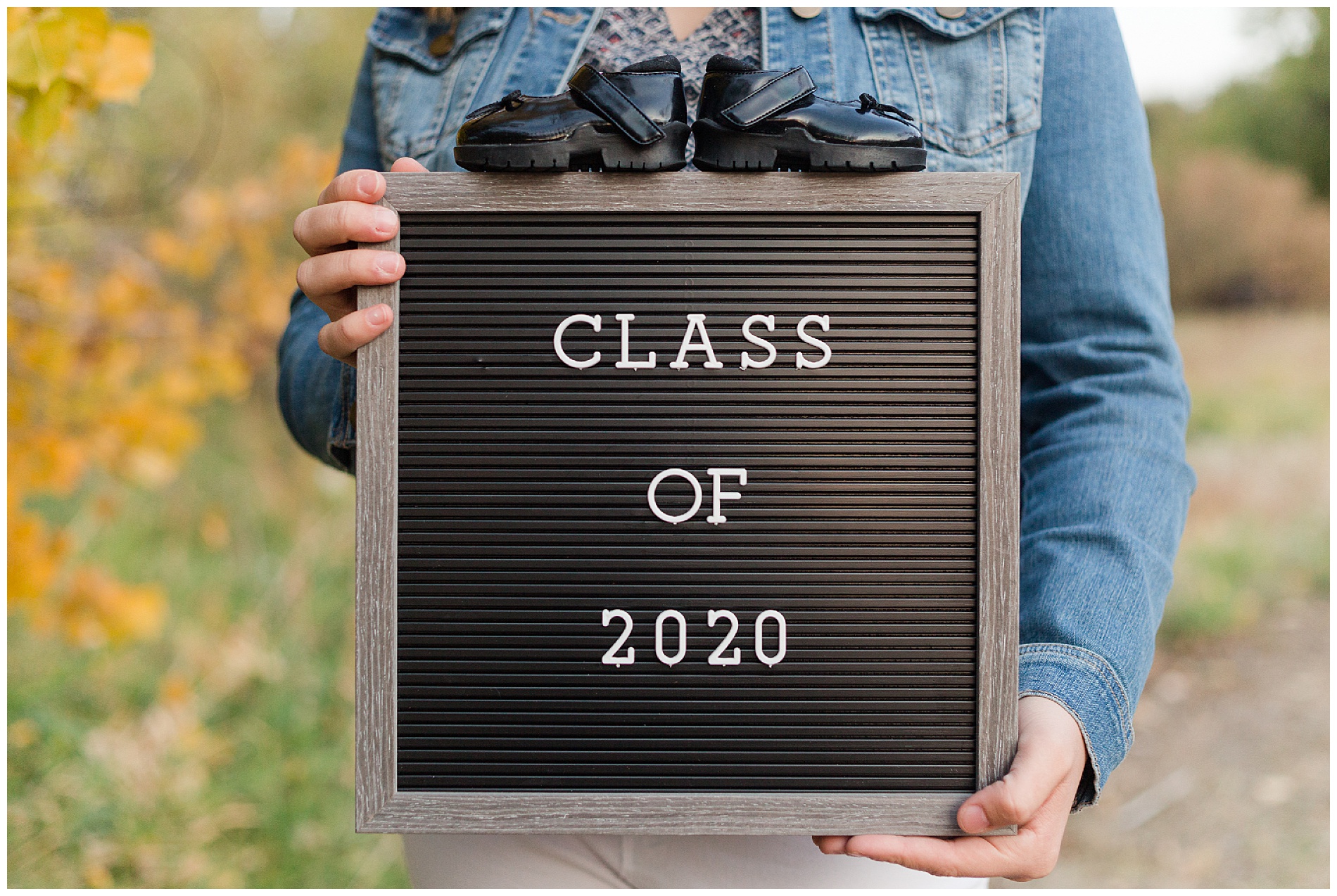 Senior photos with a letter board and baby shoes | Robin Wheeler Photography