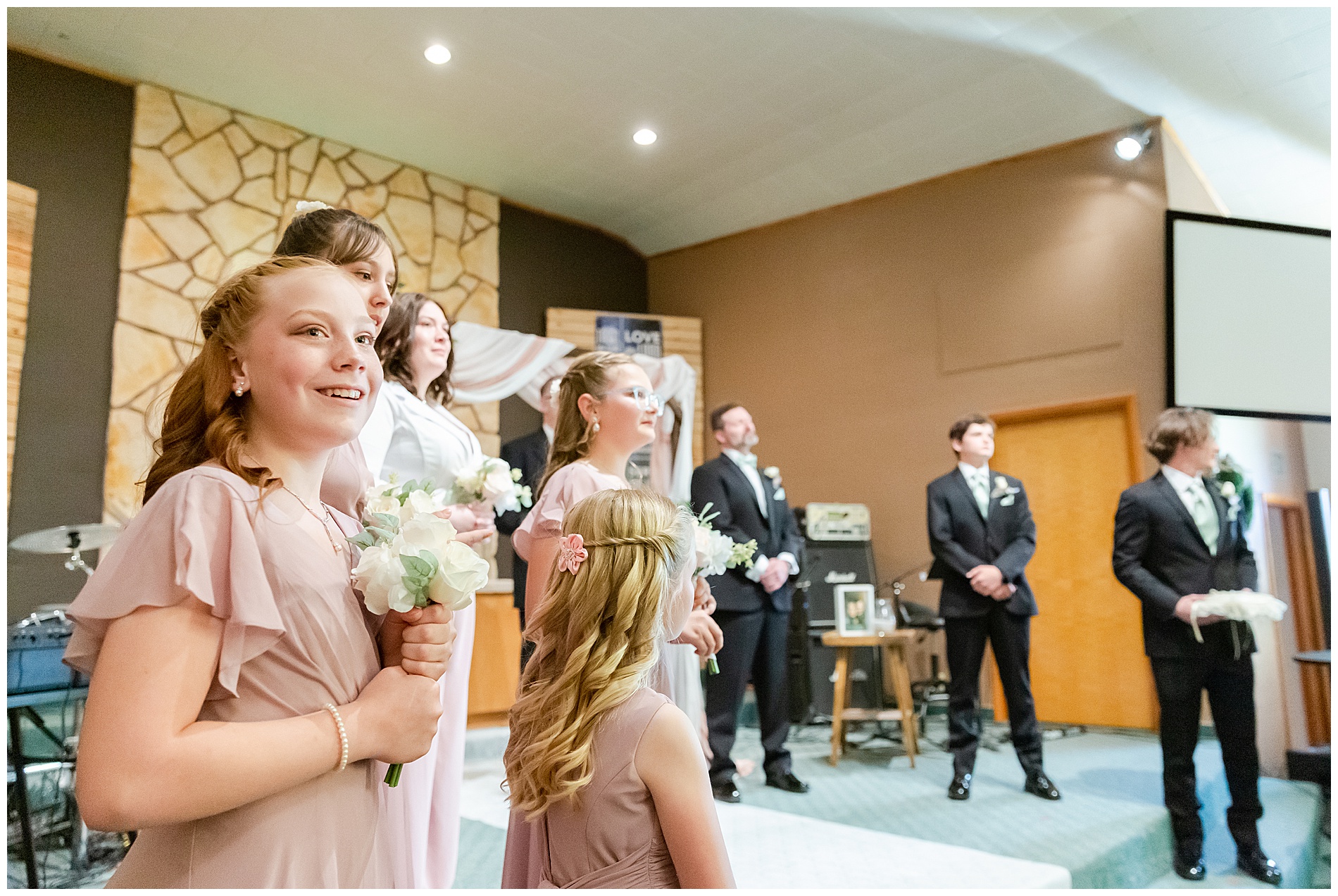 Derrick and Amanda's daughters look on as Amanda walks down the aisle