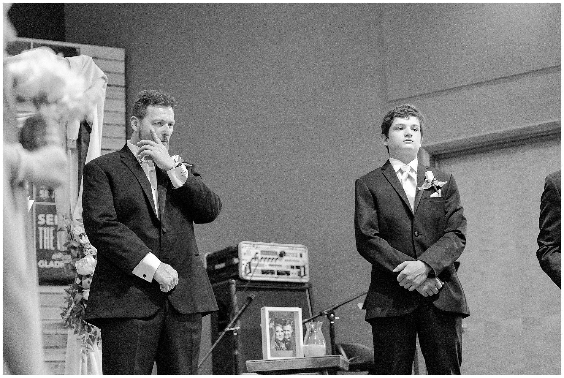 The groom wipes a tear from his cheek