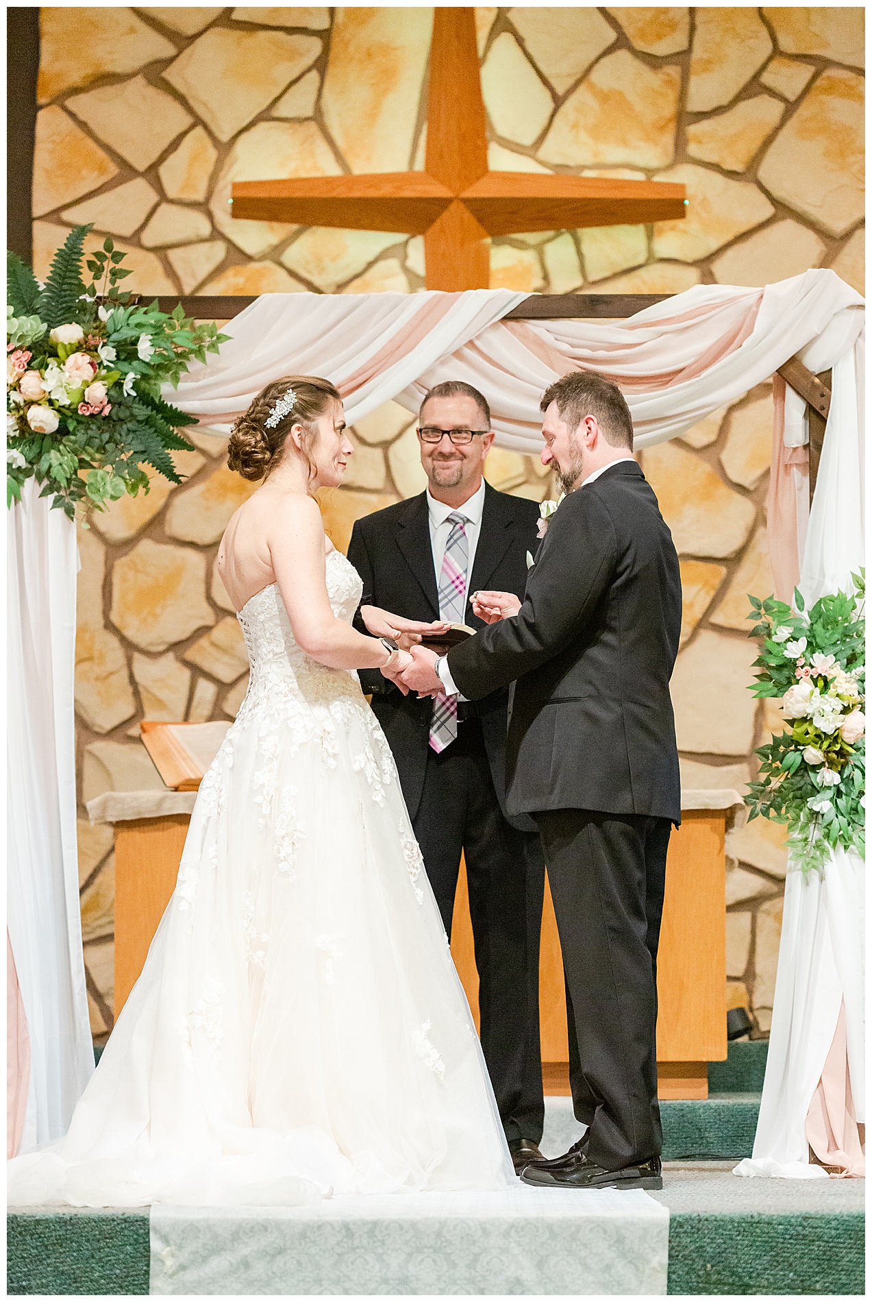 Derrick prepares to place Amanda's wedding ring on her finger