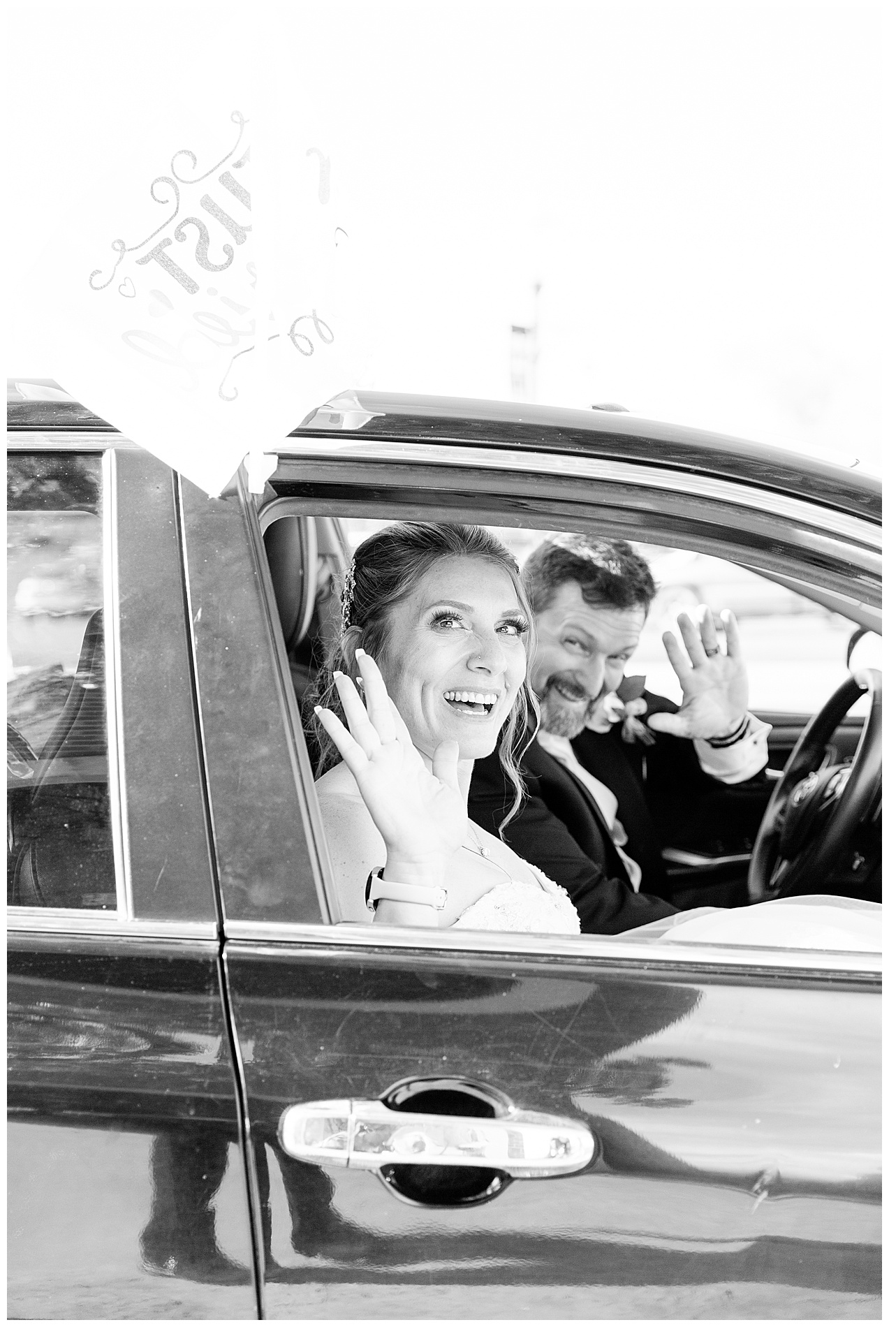 Amanda and Derrick wave out the window of their getaway car