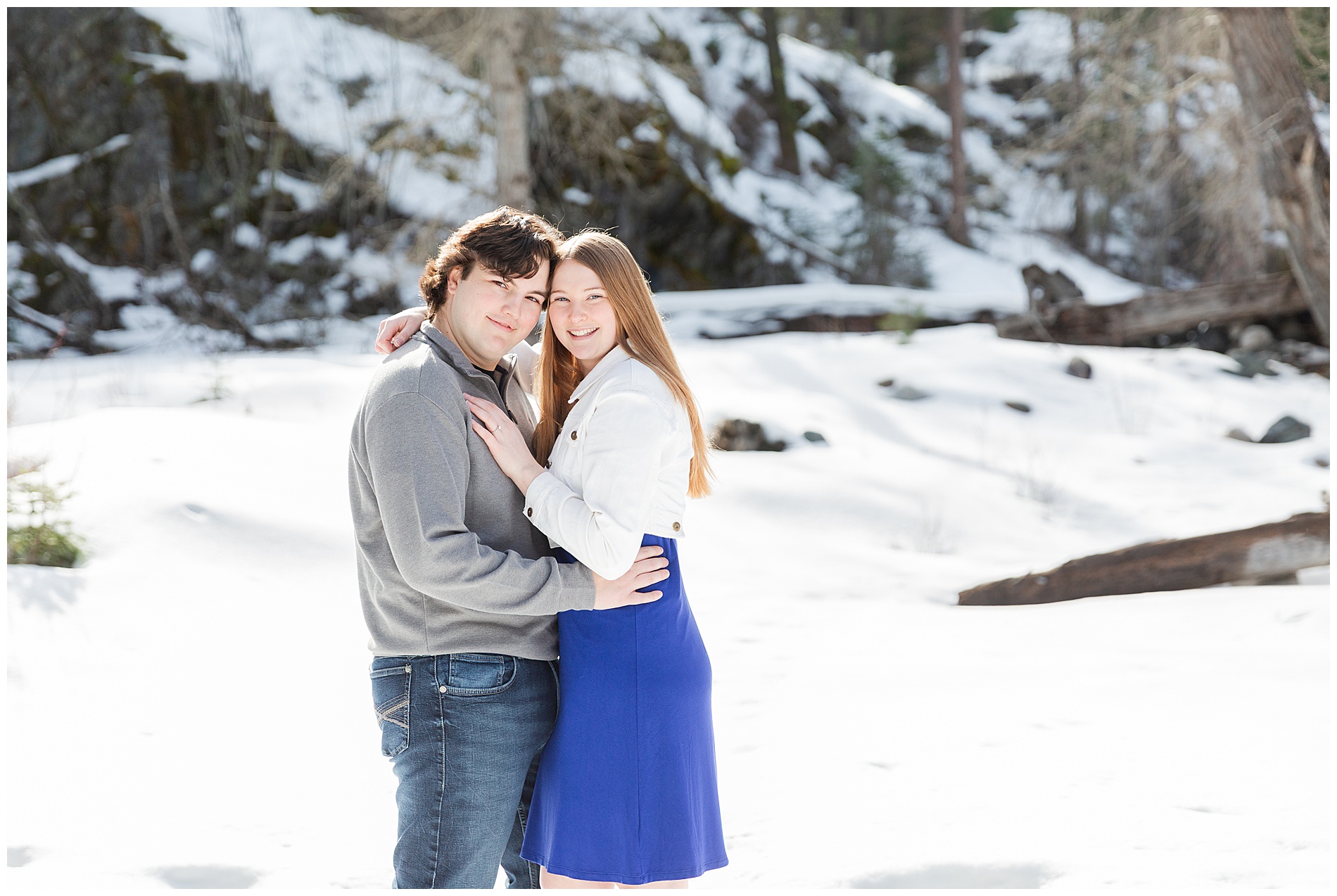 Engaged couple smiling at the camera