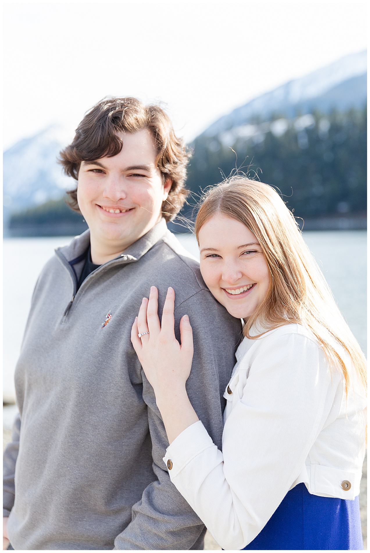 Engaged couple in gray, white, and blue