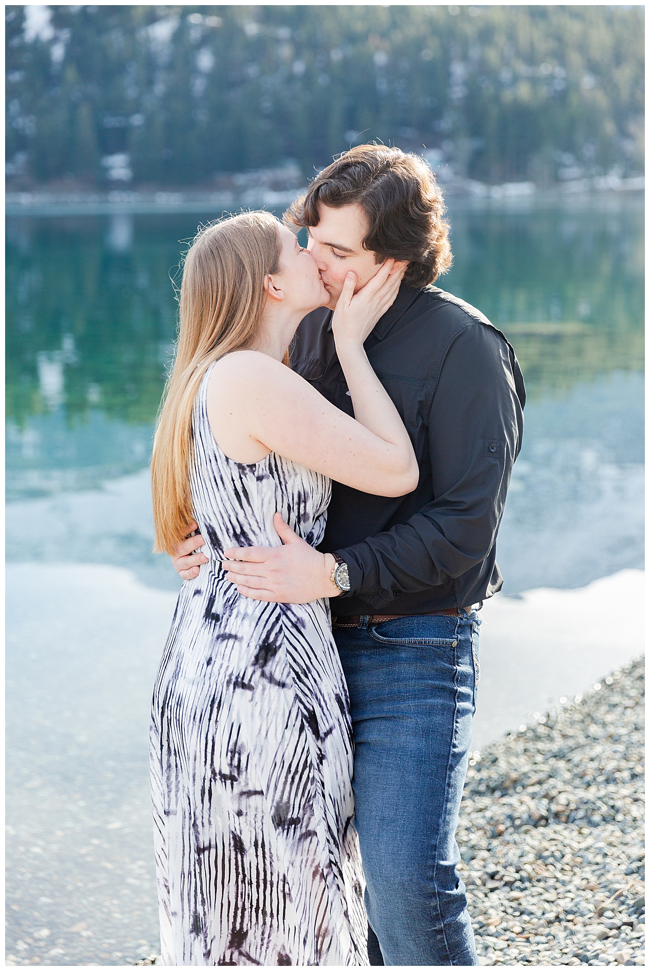 A kiss between the couple while standing on the shore of Wallowa Lake