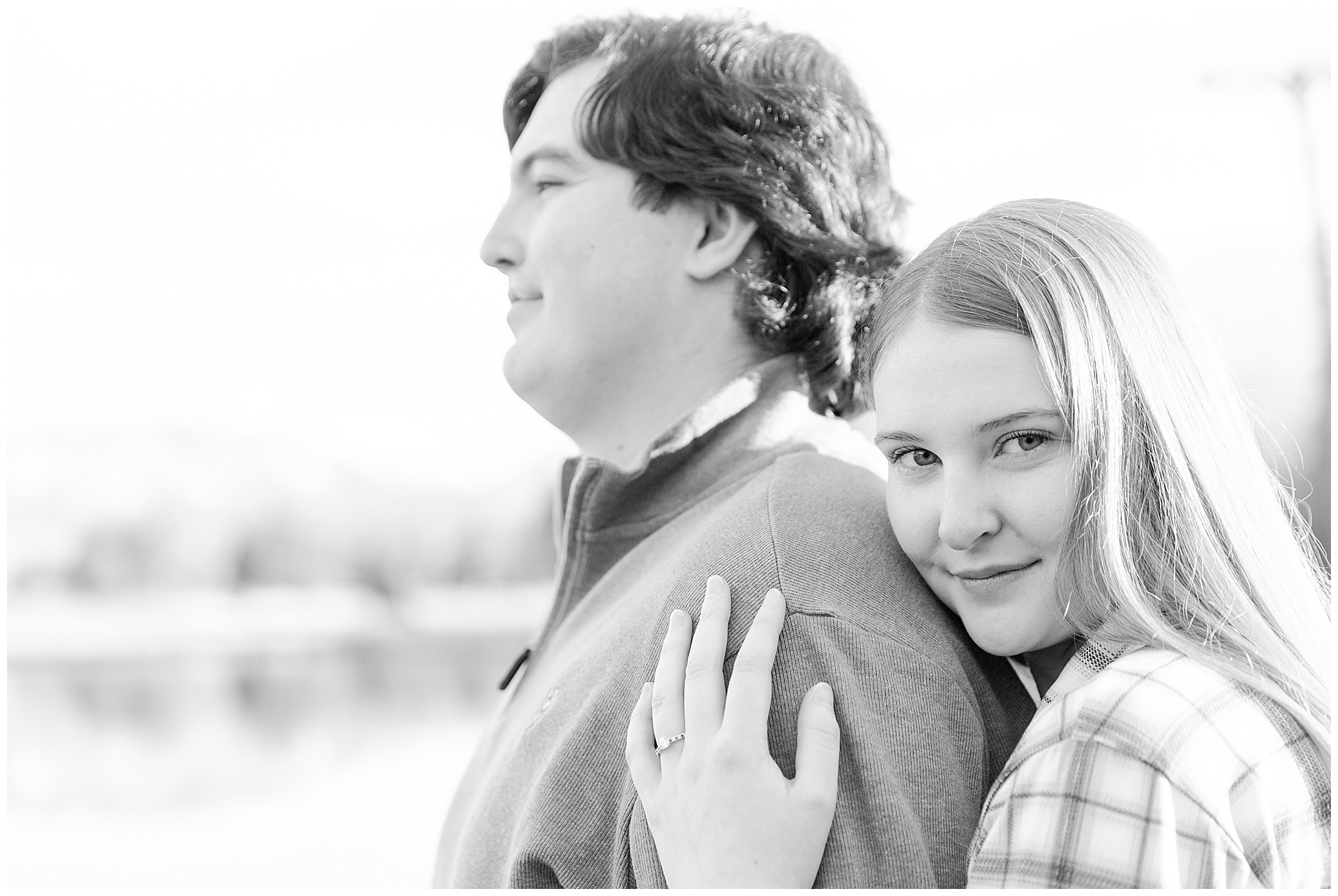 The bride-to-be rests her head on her fiancé's shoulder