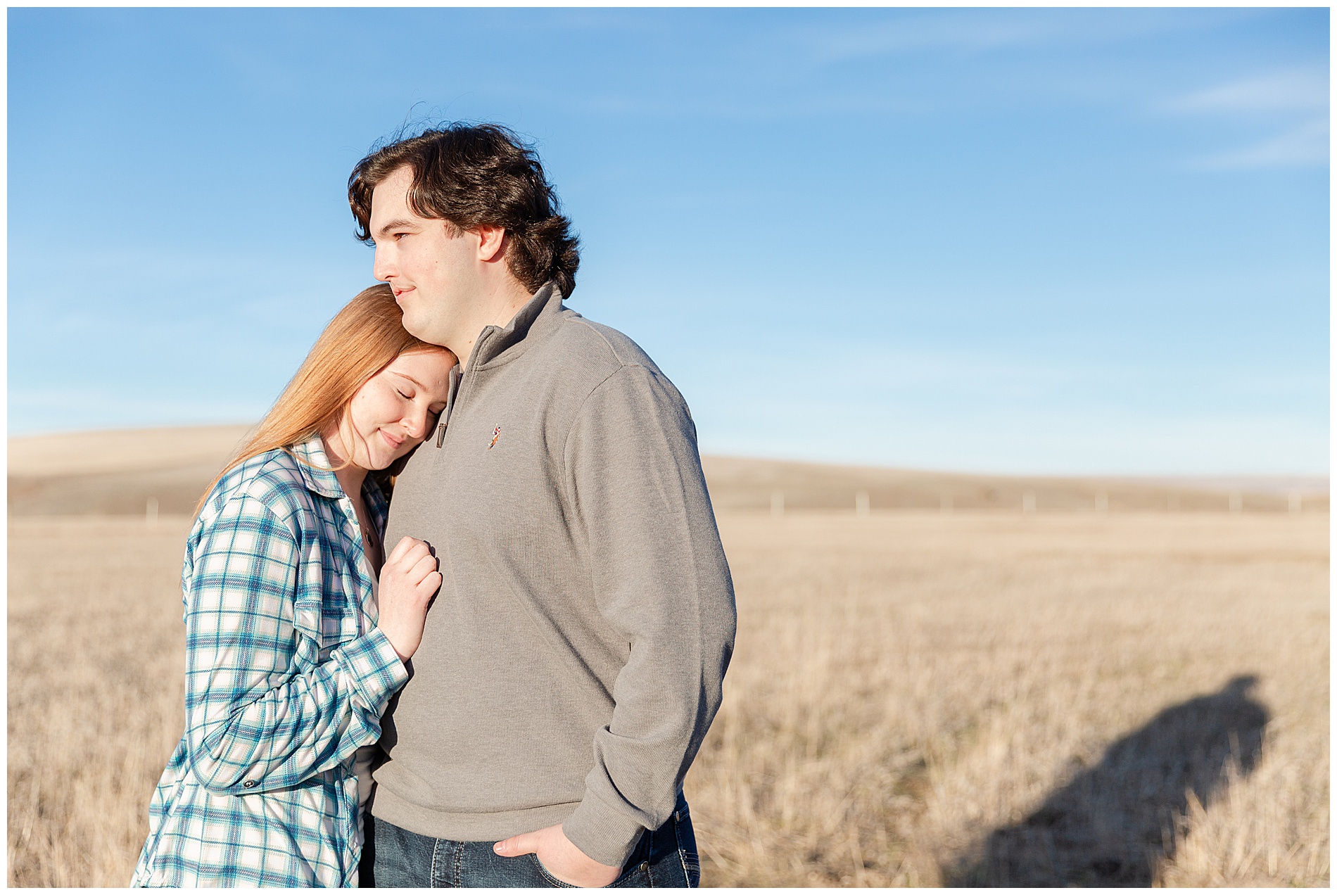 Resting her head on his shoulder with the wide open sky of Enterprise, Oregon behind them