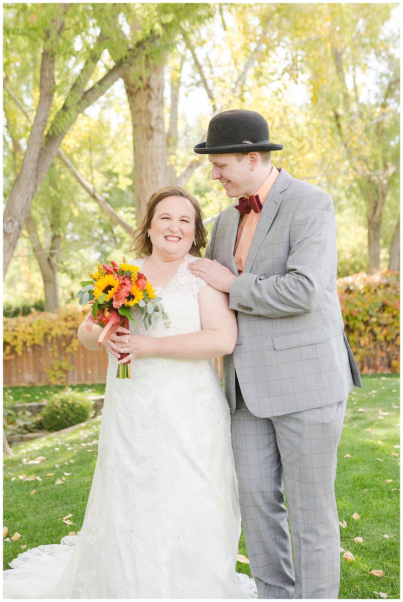 The bride and groom taking portraits before the start of their outdoor fall ceremony